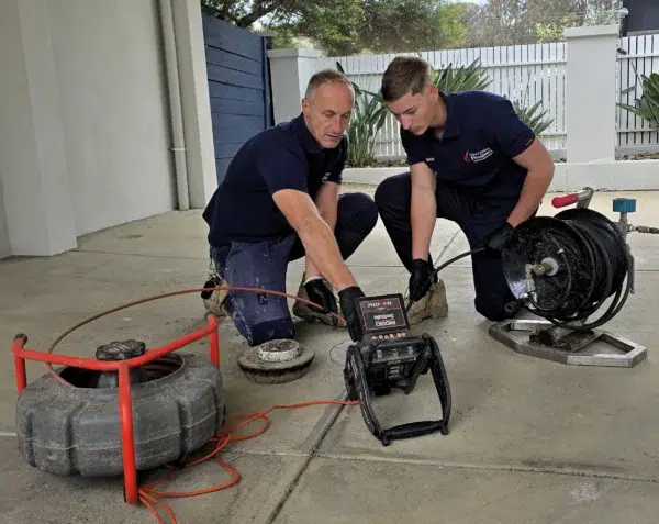 Sam and Aidan from Your Choice Plumbers using high pressure jetting and CCTV drain camera equipment for blocked drain inspection in Melbourne.