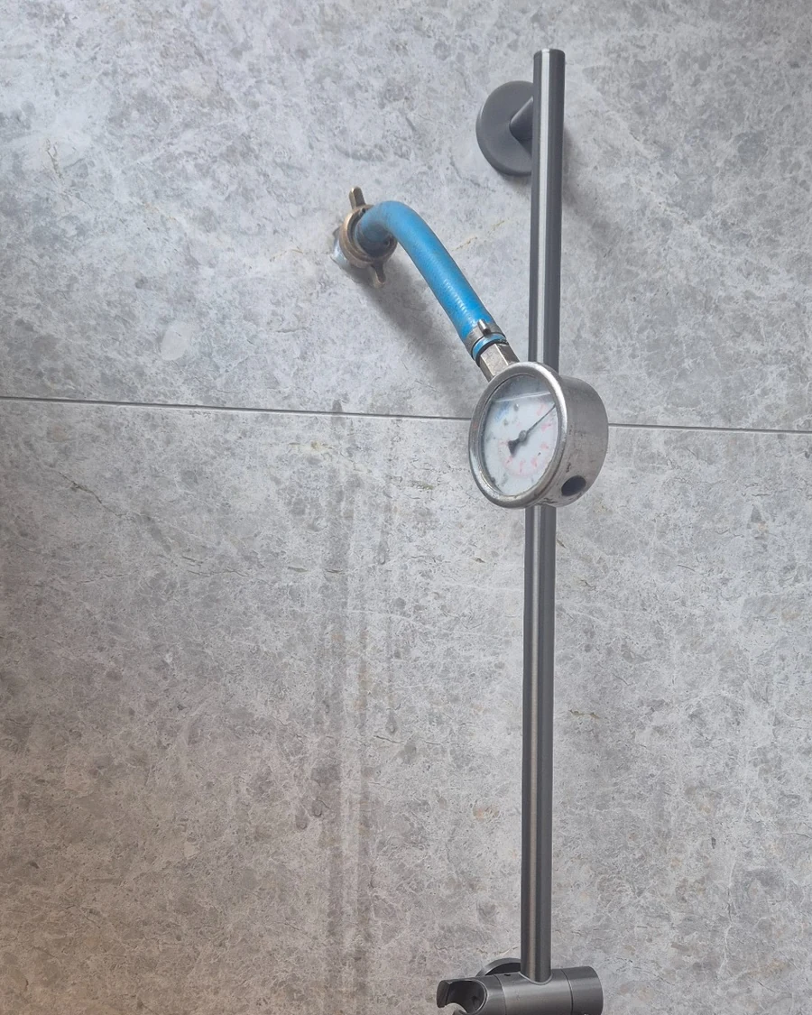 Shower water pressure testing in Canterbury using a pressure gauge during a residential leak investigation.