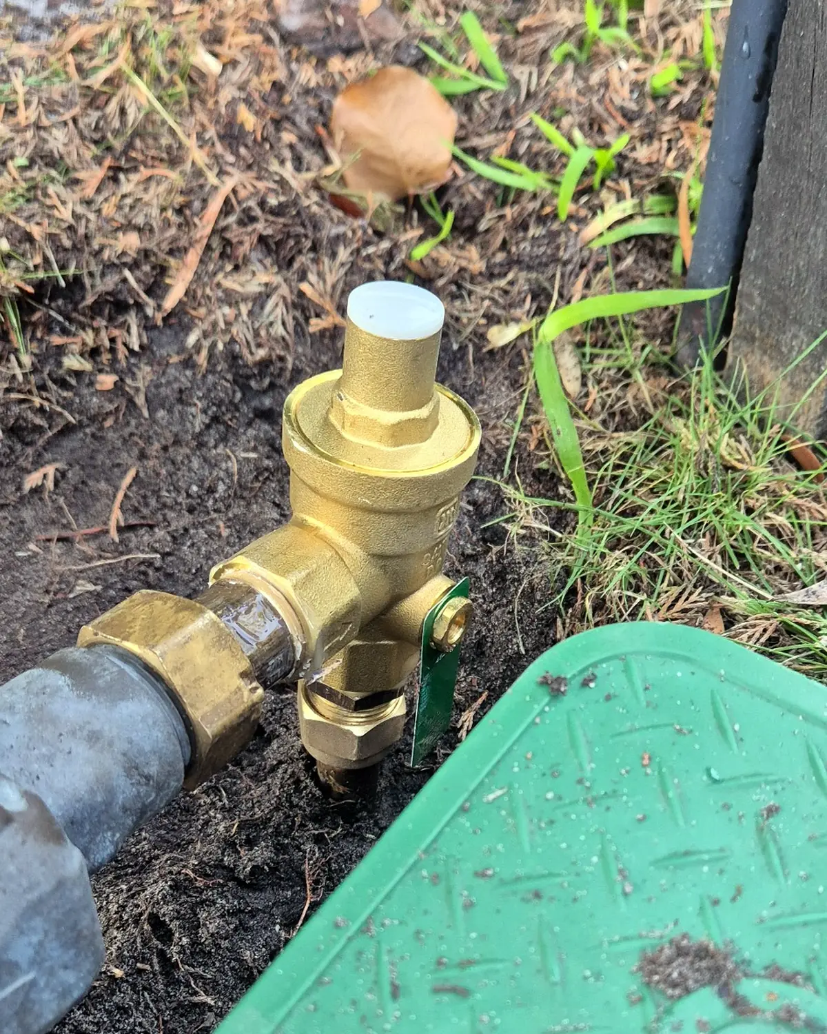 New pressure limiting valve installed on an incoming residential water supply.