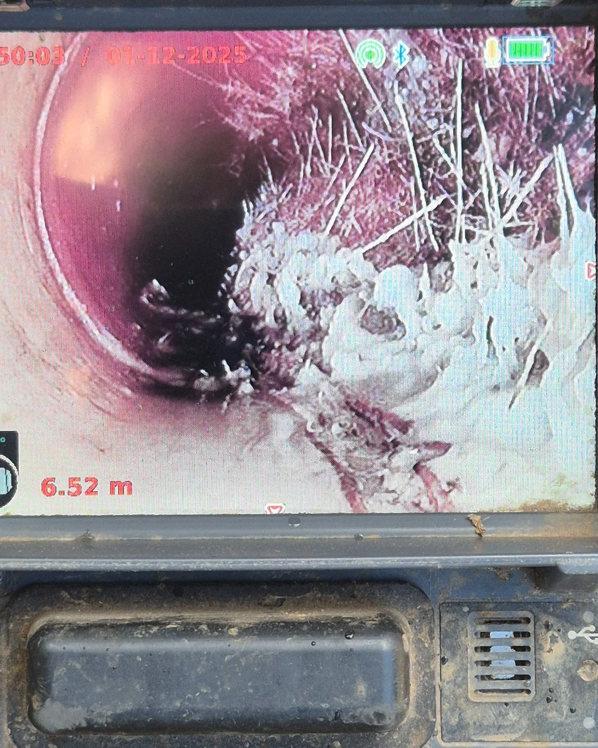 CCTV drain camera showing tree root intrusion inside terracotta drain pipe