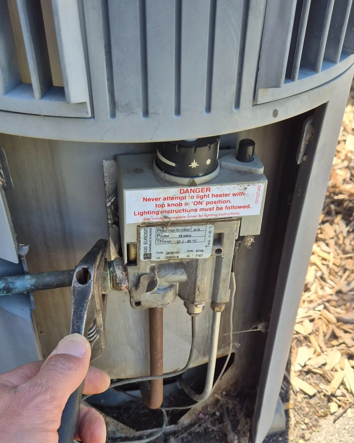 Old gas control valve being removed from a gas hot water system during repairs in Endeavour Hills.