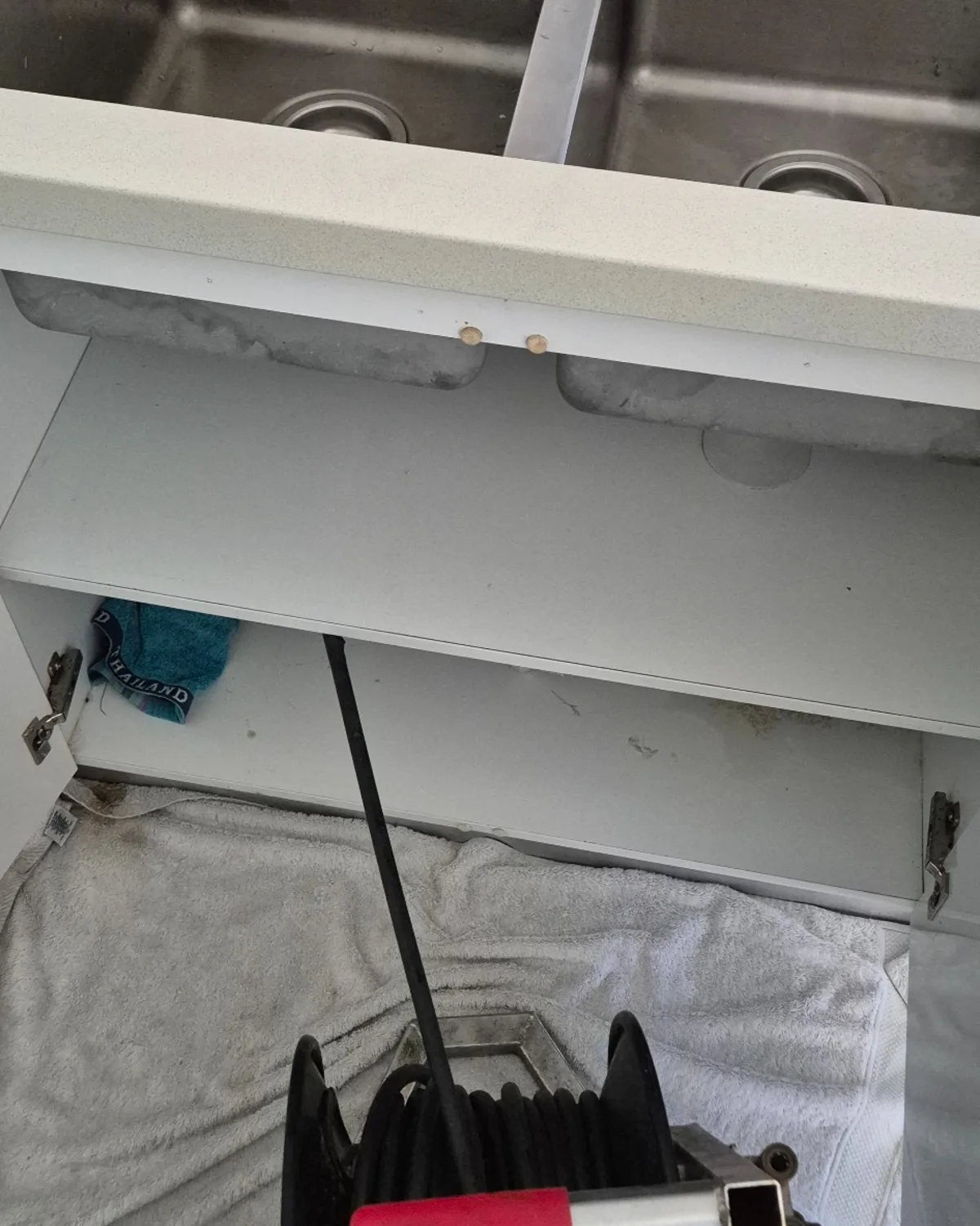 This image shows high-pressure drain cleaning being carried out internally at a kitchen drain. It is useful for the Hydro Jetting page because it highlights that jetting is not only used outside in stormwater or sewer lines, but can also be used to clear stubborn internal drain blockages.