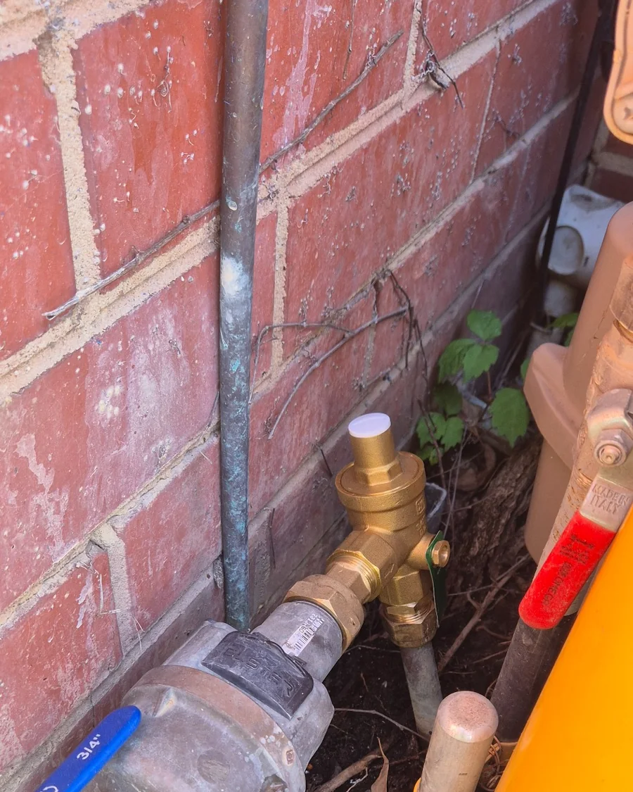 Pressure reducing valve installed at a residential water meter in Ormond to control excessive incoming water pressure.