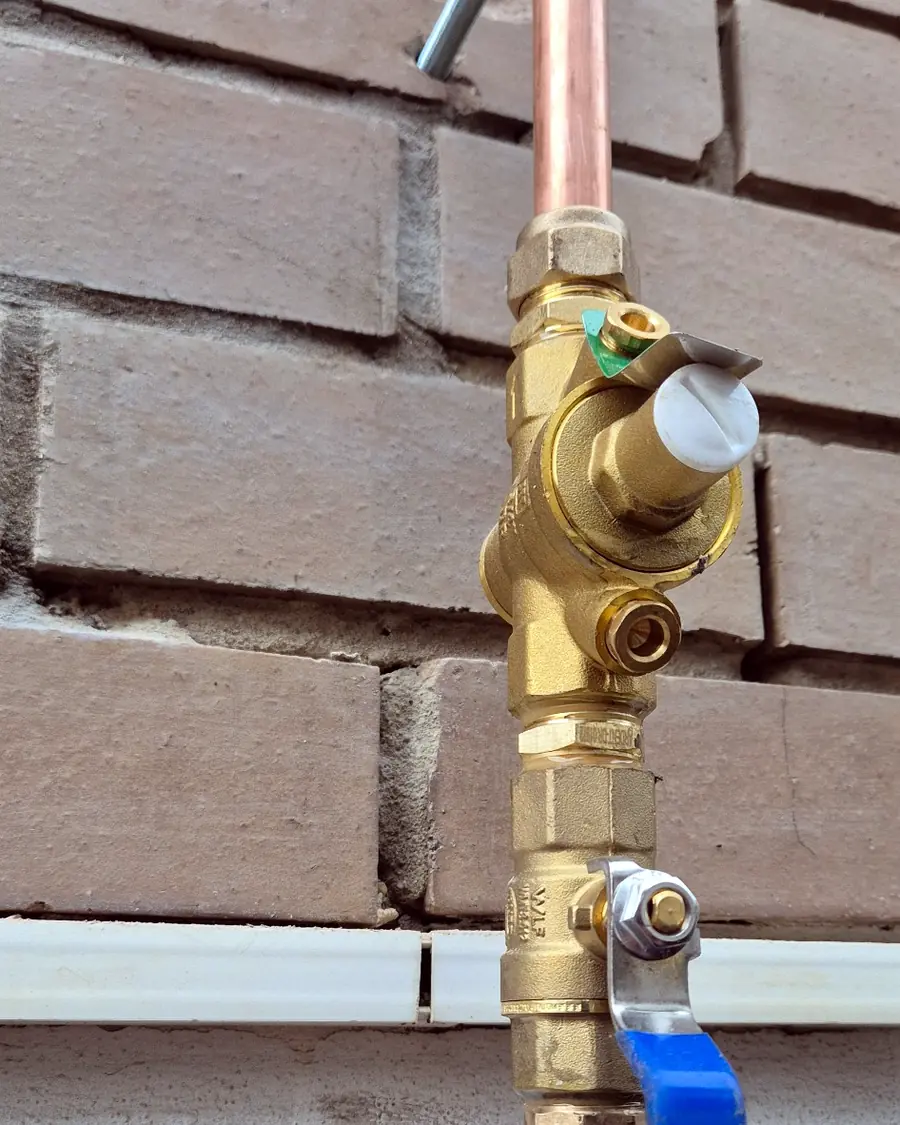 Inline pressure limiting valve and isolation valve installed on copper pipework in St Kilda.