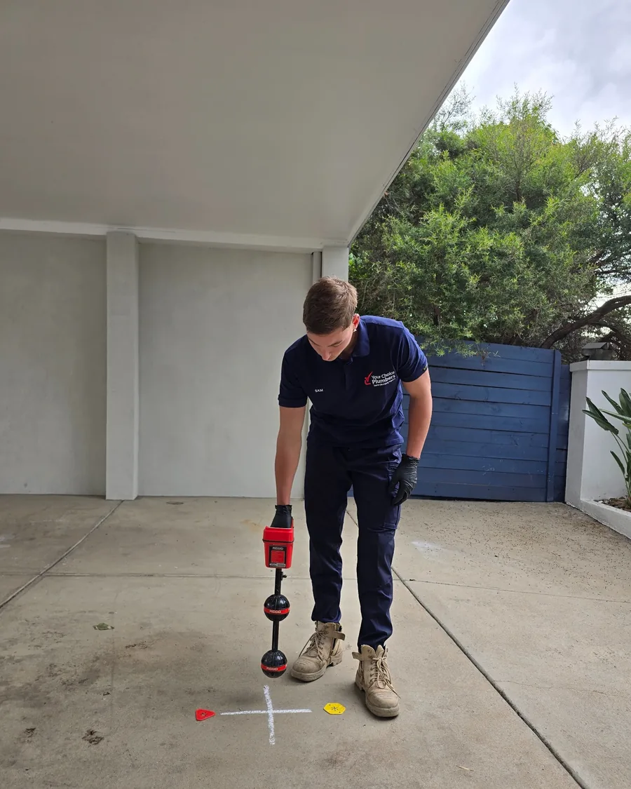 Your Choice Plumbers plumber locating an underground drain after CCTV inspection using professional pipe locating equipment.