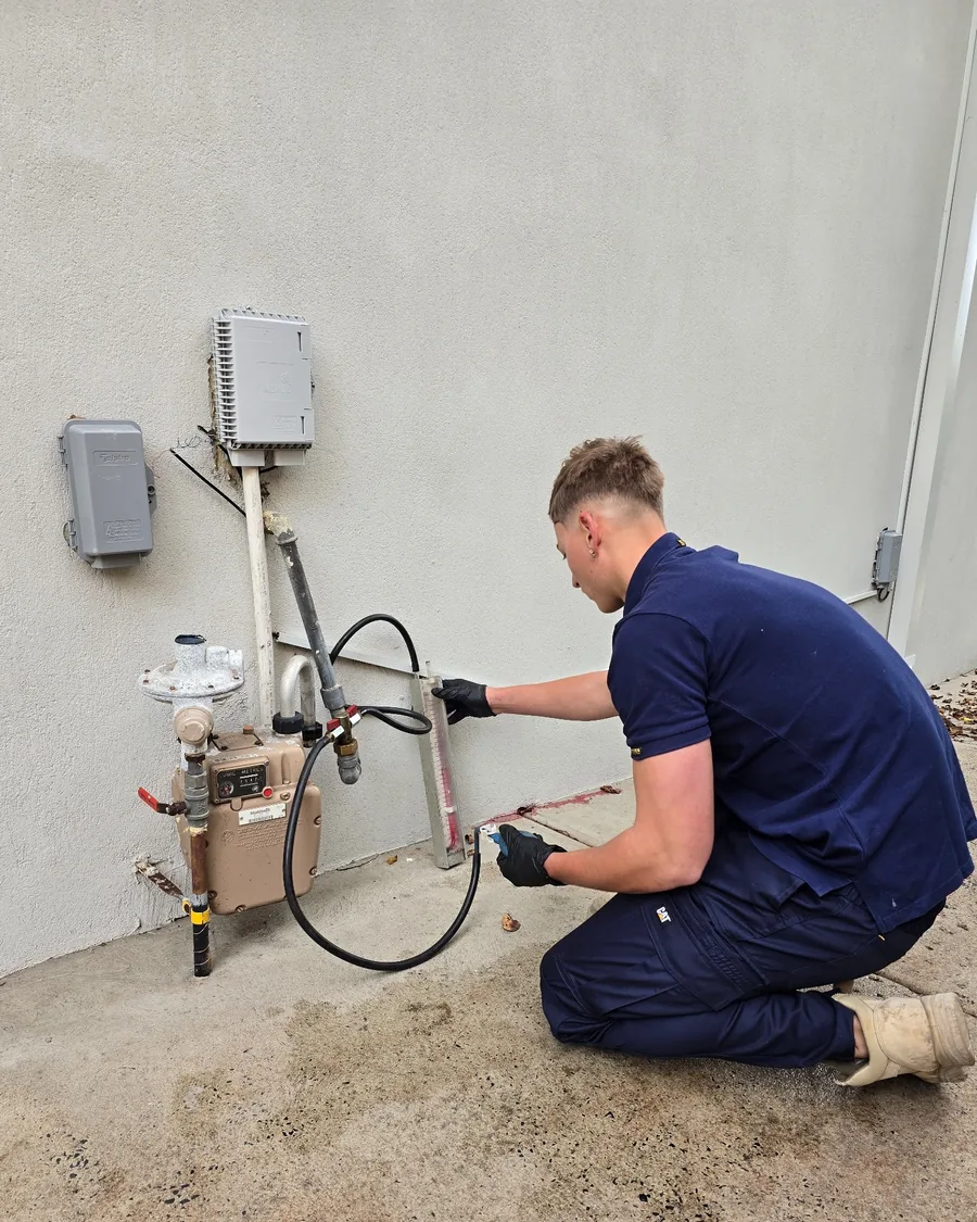 Your Choice Plumbers plumber carrying out a gas pressure test at a client’s gas meter using a manometer.