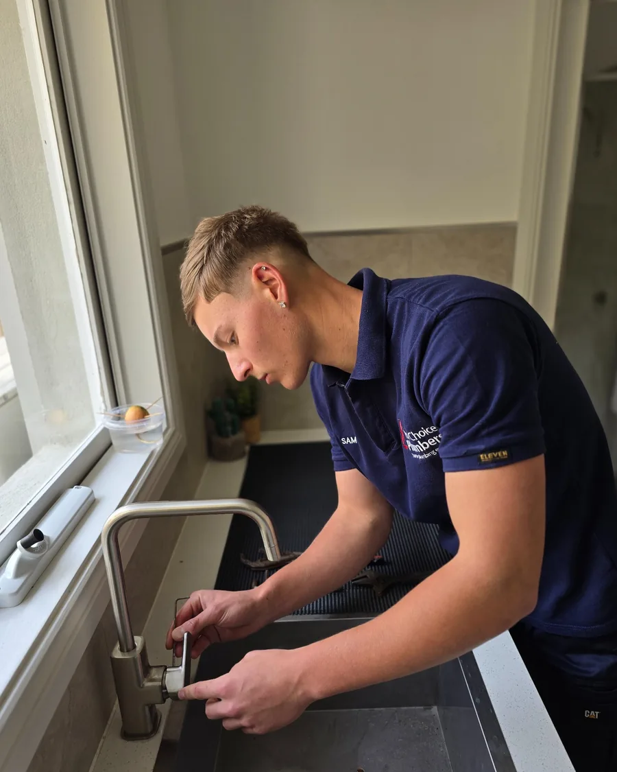 Your Choice Plumbers plumber servicing a kitchen mixer tap at a client’s home.
