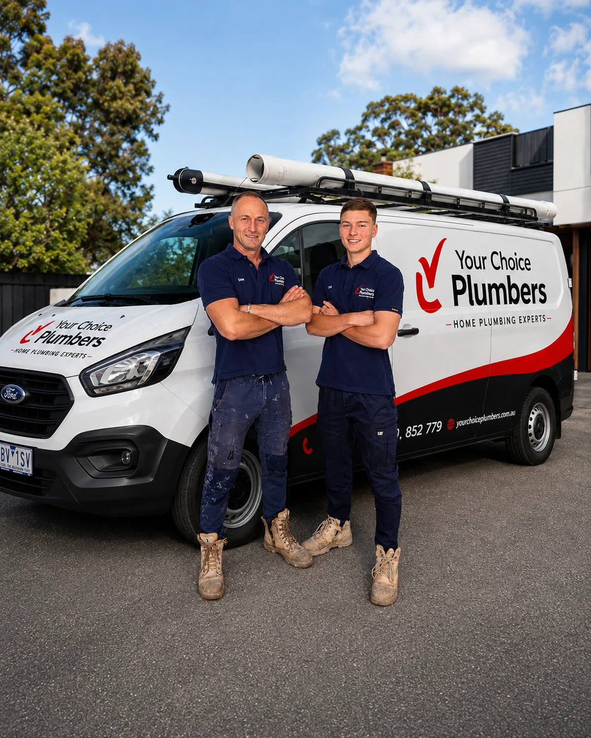 Your Choice Plumbers plumbers Sam and Aidan standing beside the fully branded plumbing service van.