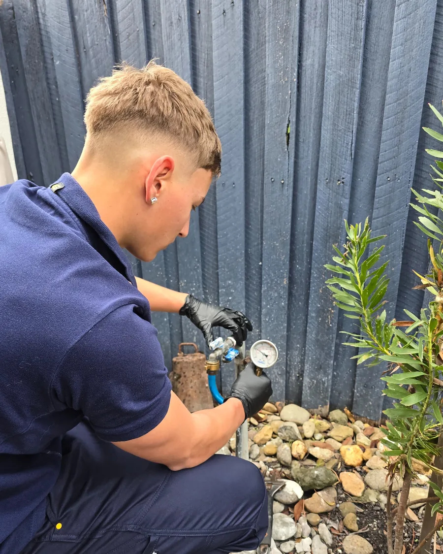 Your Choice Plumbers plumber checking water pressure at a client’s home using a water pressure gauge.