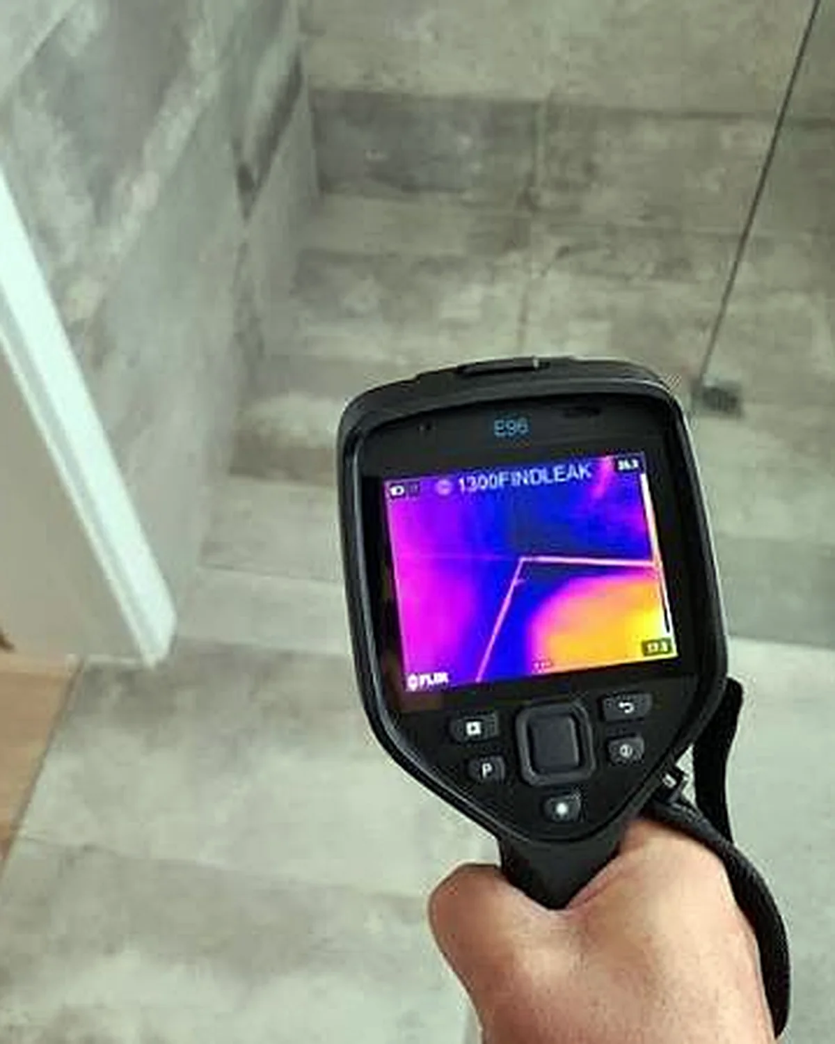 Thermal imaging camera detecting a hidden water leak around a shower area.